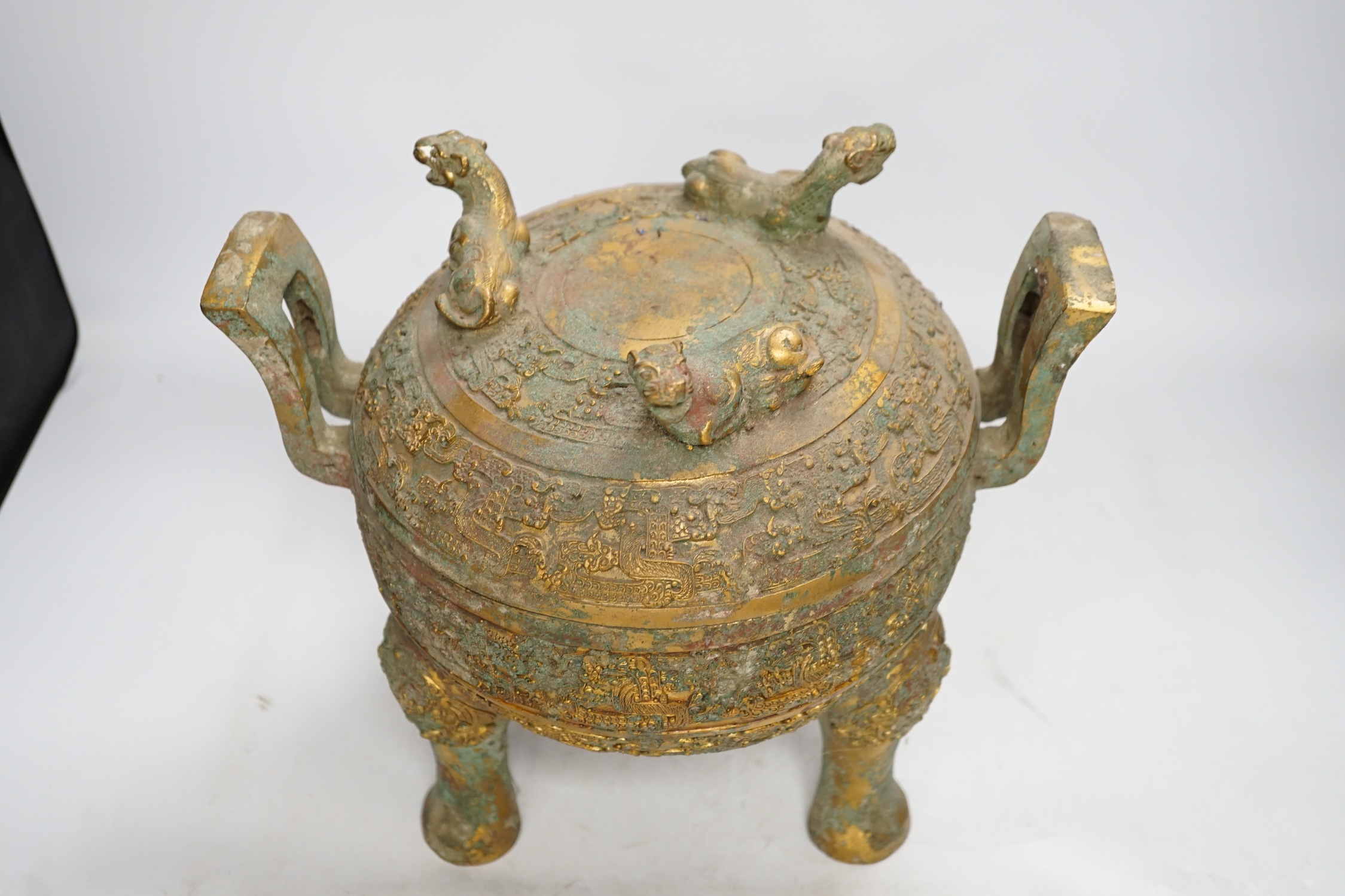 A Chinese archaistic bronze tripod censor and cover with tiger finials, height 18cm. Condition - fair for age